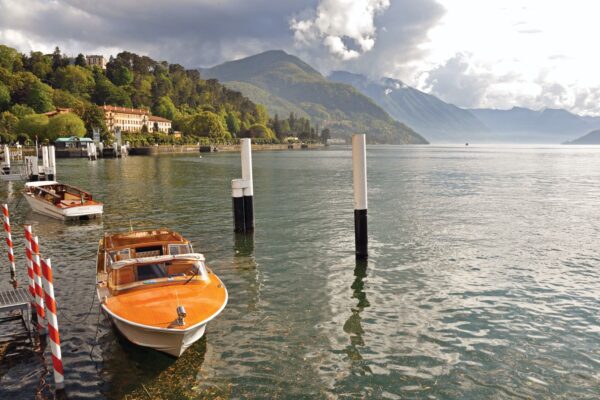 View Of Lake Como In A Cloudy Day With Motorboat And Harbor — Romantic Italy honeymoon by Italy Travel Specialist